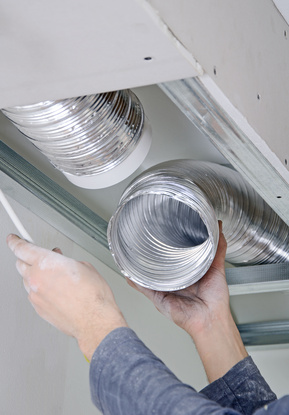 Male hands setting up ventilation system indoors